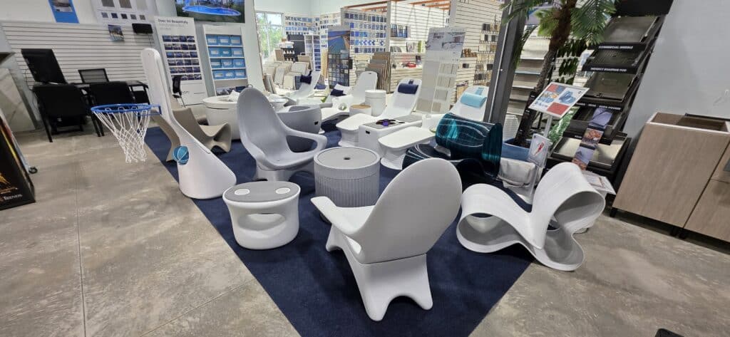 White and gray in-pool loungers and seating displayed at the Innovative Outdoor Living showroom
