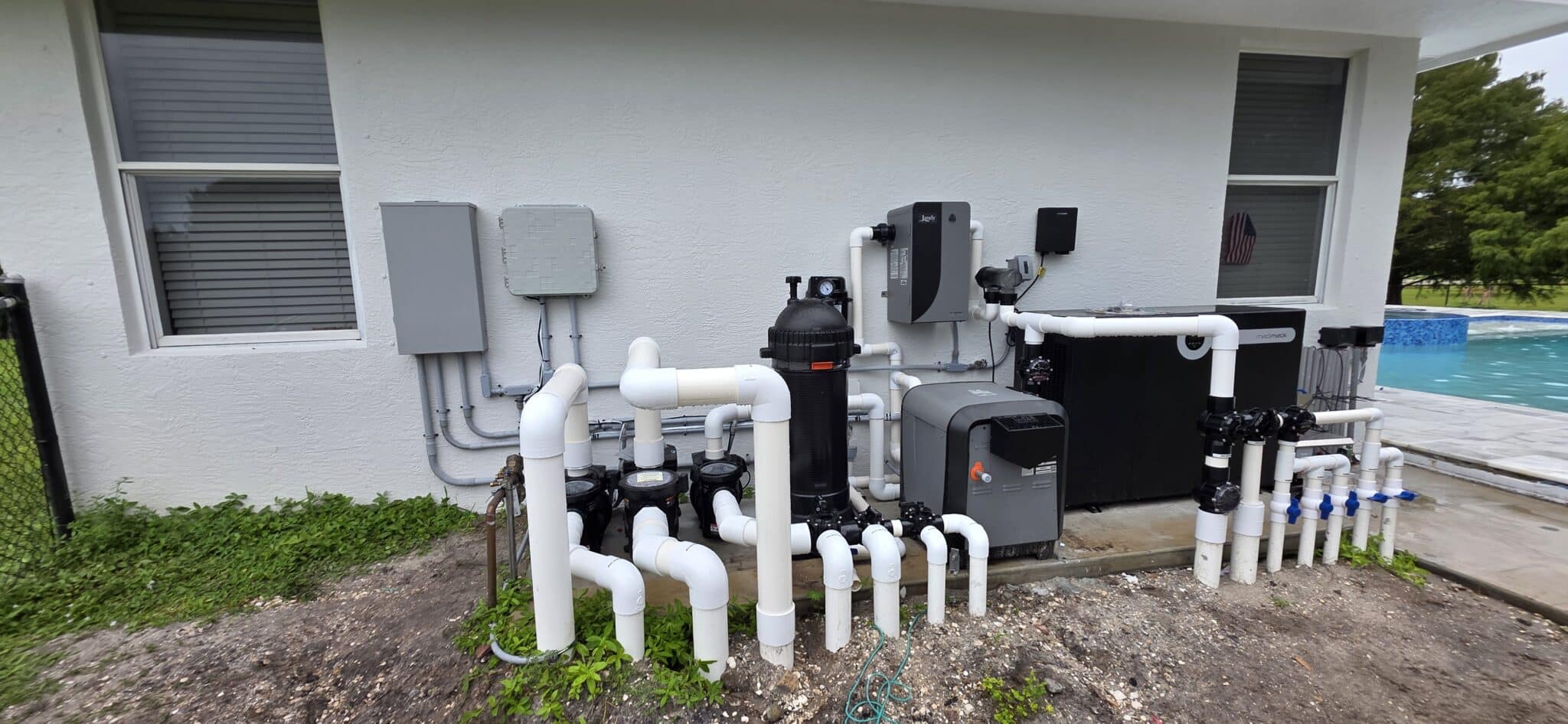 Pool equipment installation with pumps, filter, heaters and control panels